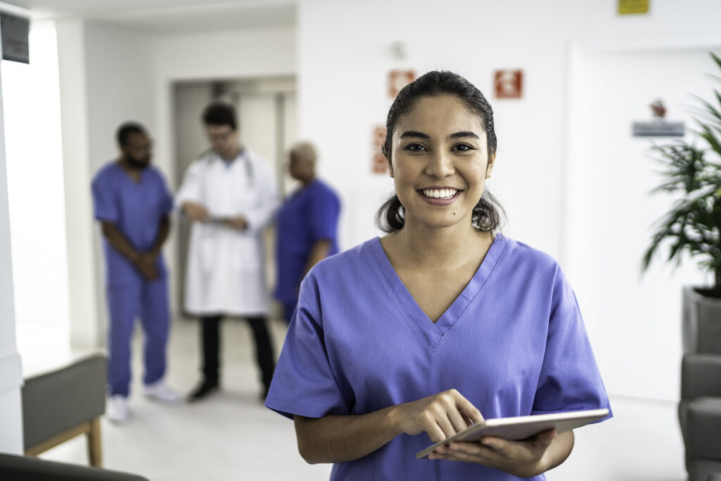 Portrait of female nurse using tablet at hospital