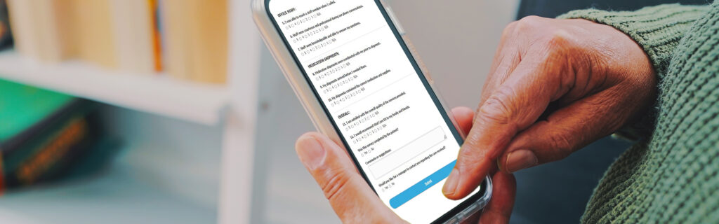 Cropped shot of an unrecognizable senior woman holding a mobile phone with a green screen while sitting in the living room of her apartment, uses citus health on mobile phone