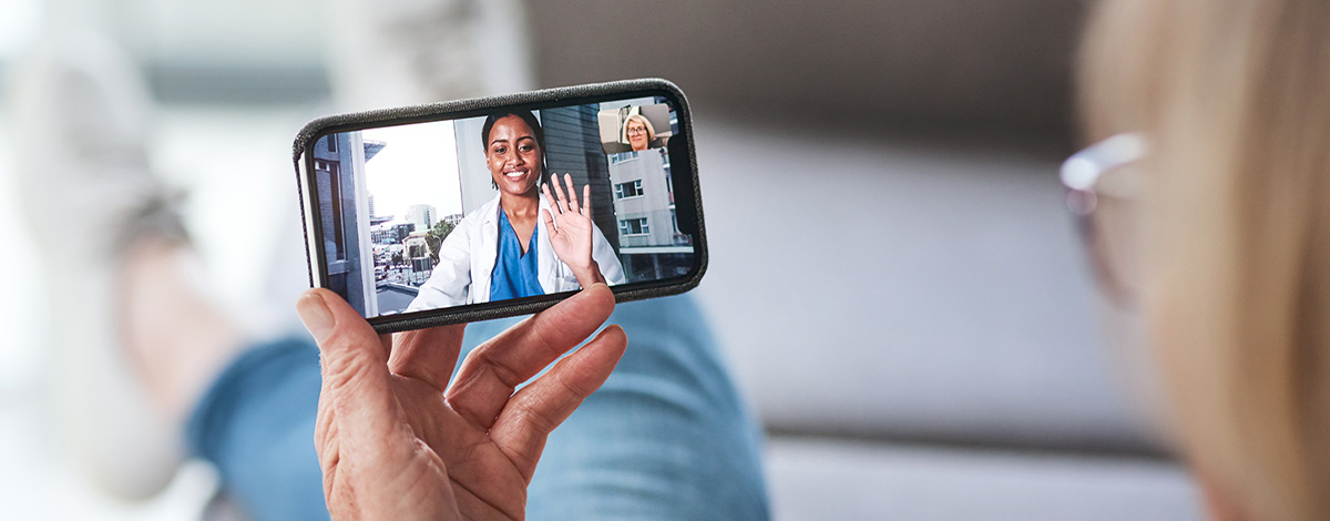 patient speaks with healthcare professional via video chat on smart phone
